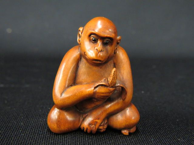 Appraisal: Carved Wood Netsuke of a Monkey eating a banana onyx