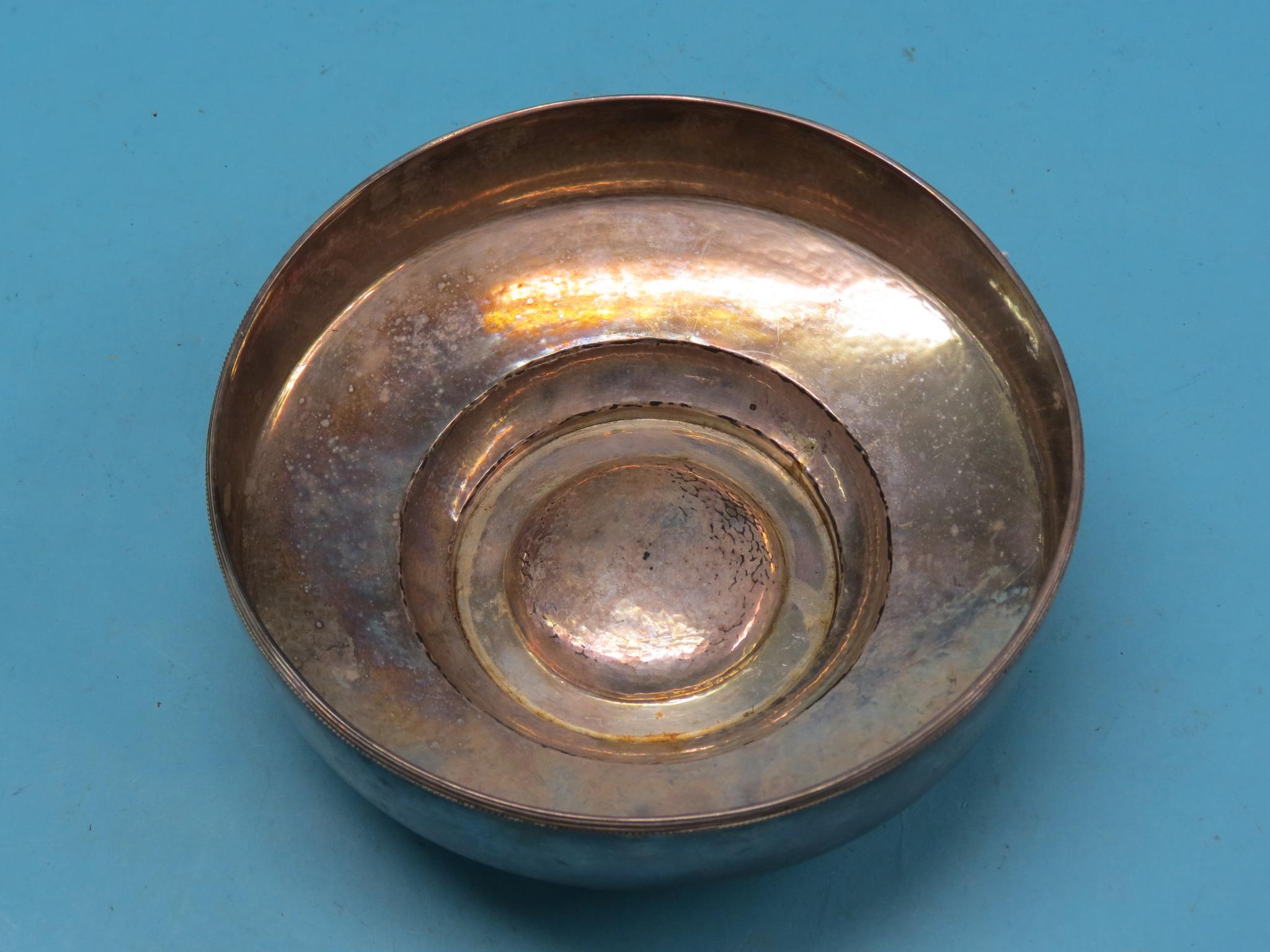 Appraisal: A continental hammered silver bowl raised boss to centre stamped