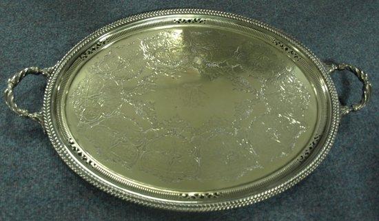 Appraisal: A two-handled oval tray with central monogram and pierced rim