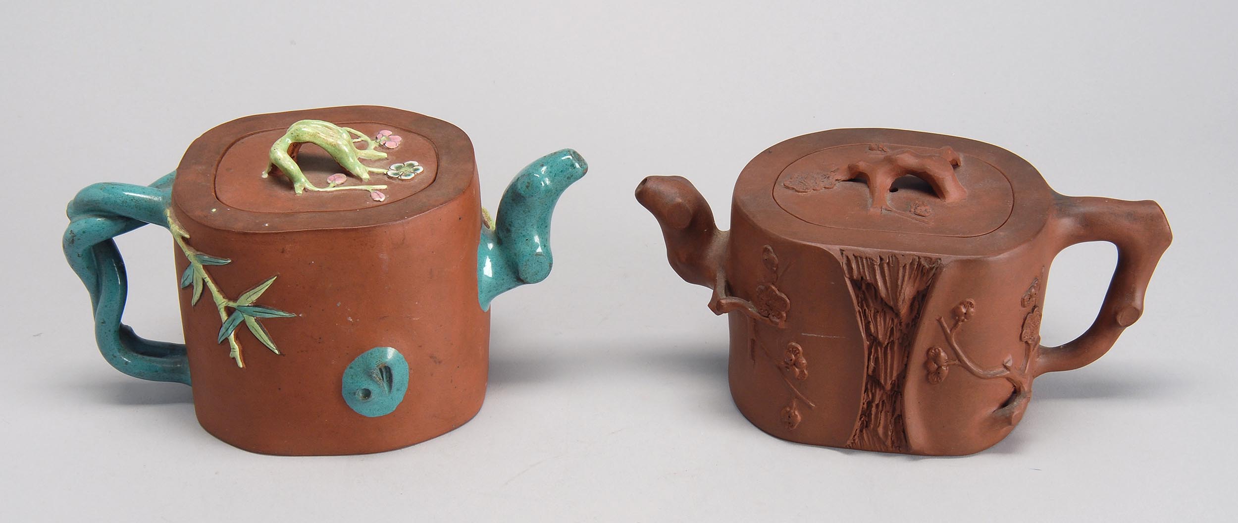 Appraisal: TWO YIXING POTTERY TEAPOTS Early th CenturyBoth in tree stump