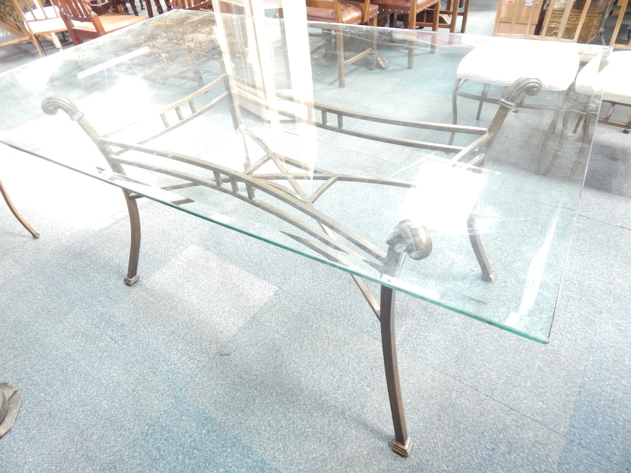 Appraisal: A glass topped dining table with cast iron base with