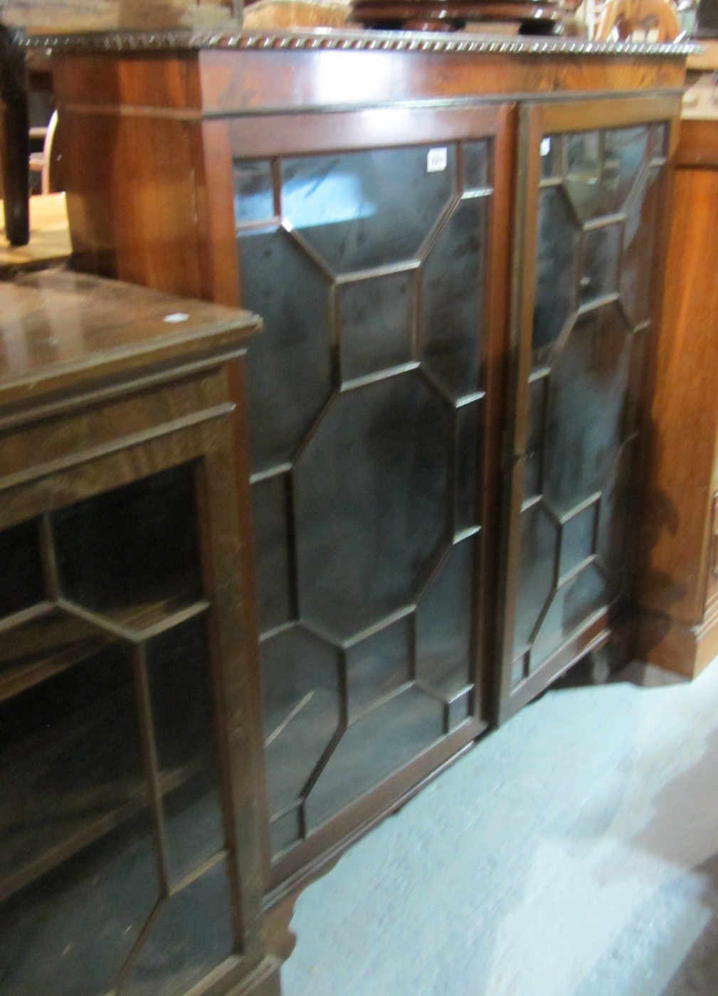 Appraisal: A mahogany floor standing astragal glazed two door bookcase on