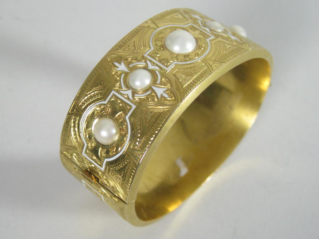 Appraisal: A Continental hinged Bangle the front set five half-pearls with