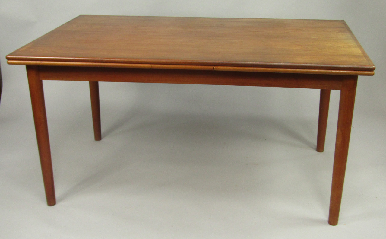 Appraisal: A 's teak drawleaf dining table raised on tubular legs