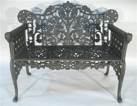 Appraisal: BLACK PAINTED WROUGHT IRON GARDEN BENCH th century the shaped