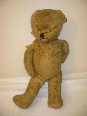 Appraisal: An English straw filled teddy bear covered in gold plush