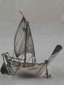 Appraisal: A silver model of an Arab dhow with lateen sail