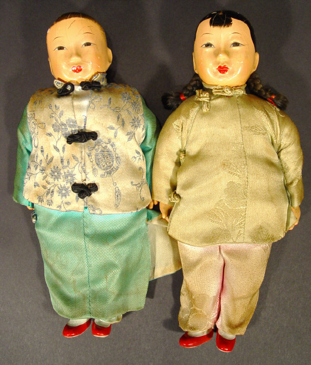 Appraisal: Two Chinese dolls with hand painted papier mache heads and