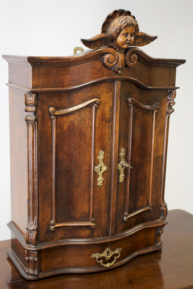 Appraisal: Baroque Revival Wall or Table Cabinet w Putto Mahogany Baroque