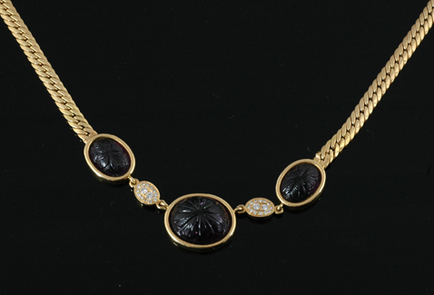 Appraisal: An amethyst and diamond necklace The three oval shaped carved