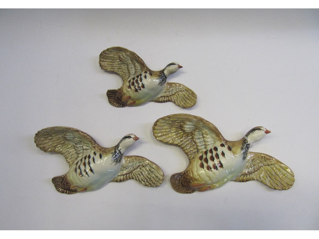 Appraisal: Three Beswick flying Pink Legged Partridges