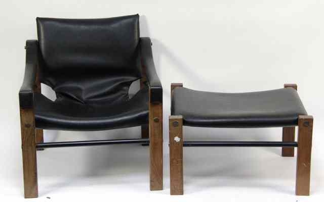 Appraisal: An Arkana armchair with padded seat back and strapped arms