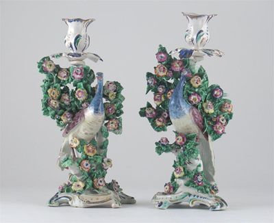 Appraisal: A pair of Bow peacock candlesticks each bird before flowering