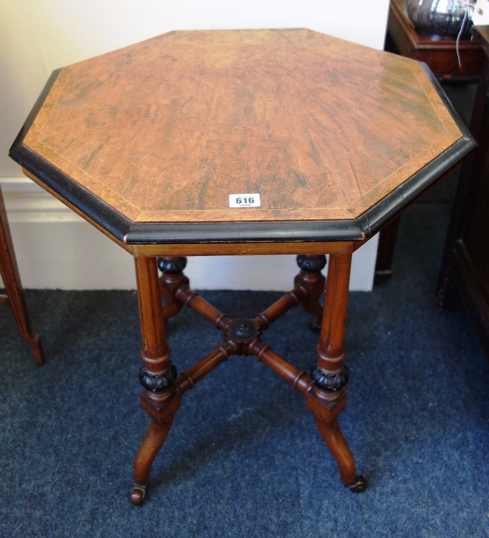 Appraisal: An Aesthetic period walnut and ebonised window table the octagonal