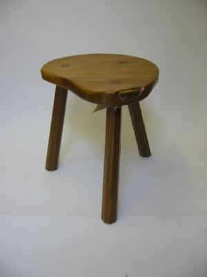 Appraisal: A YORKSHIRE ADZED OAK STOOL of kidney form raised on