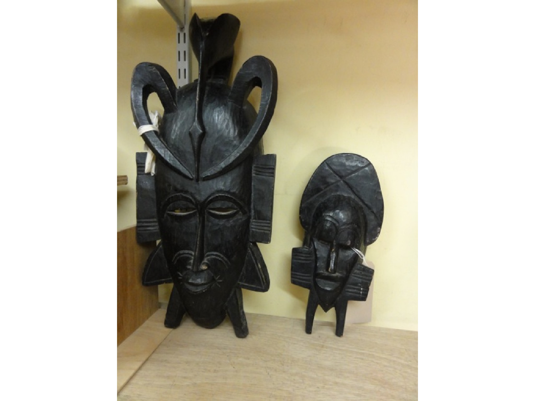 Appraisal: An African stained and carved timber wall mask cm tall