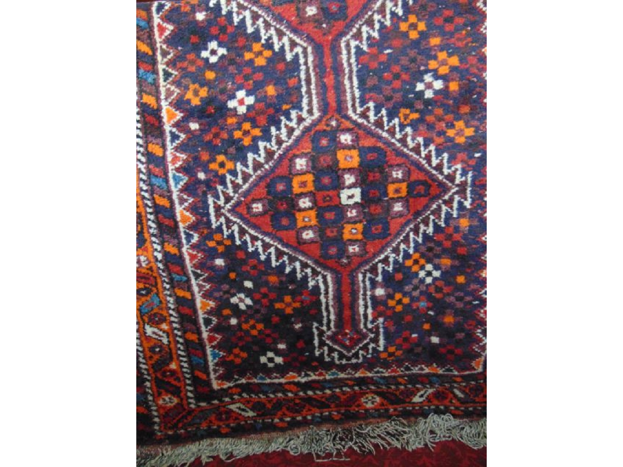 Appraisal: A Persian wool rug with multi medallion centre upon a