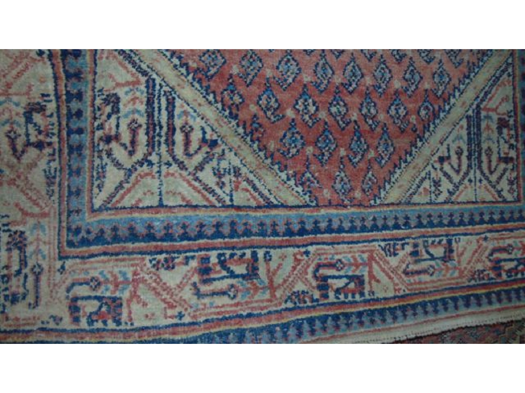 Appraisal: A Persian style wool rug with pale salmon ground field