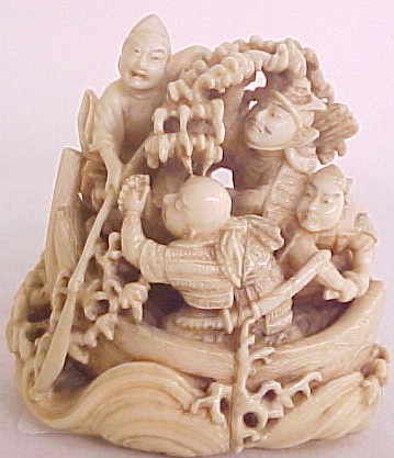 Appraisal: Japanese carved ivory netsuke Meji period boat with samurai warriors