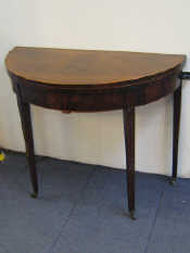 Appraisal: A Georgian mahogany folding circular table with boxwood stringing tapered