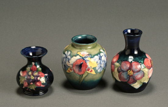 Appraisal: Group of Three Moorcroft Cabinet Vases The first an 'Orchid'