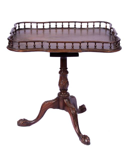 Appraisal: A George III style tea table with gallery losses and