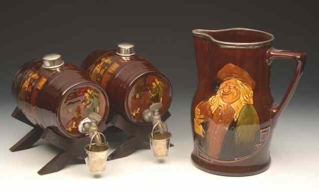 Appraisal: A PAIR OF ROYAL DOULTON BROWN GLAZED SILVER MOUNTED SPIRIT