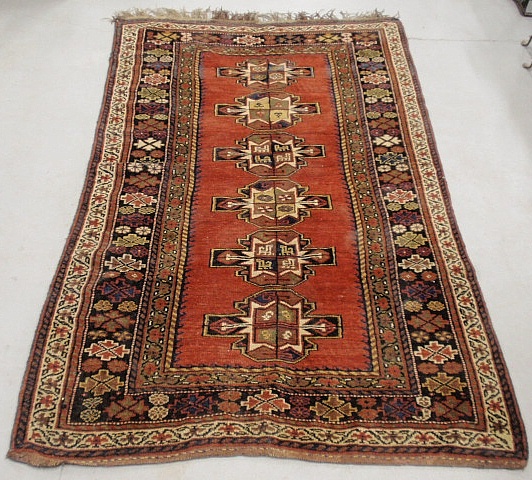 Appraisal: - Kazak style oriental center hall carpet with red field