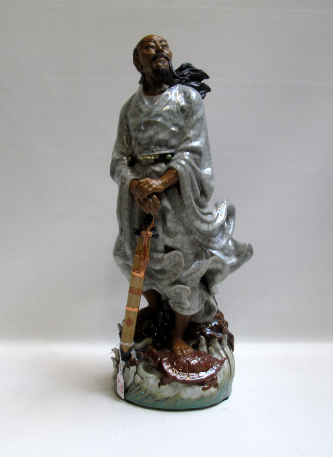 Appraisal: CHINESE POTTERY DEITY SCULPTURE depicting a standing Yuan Wu figure