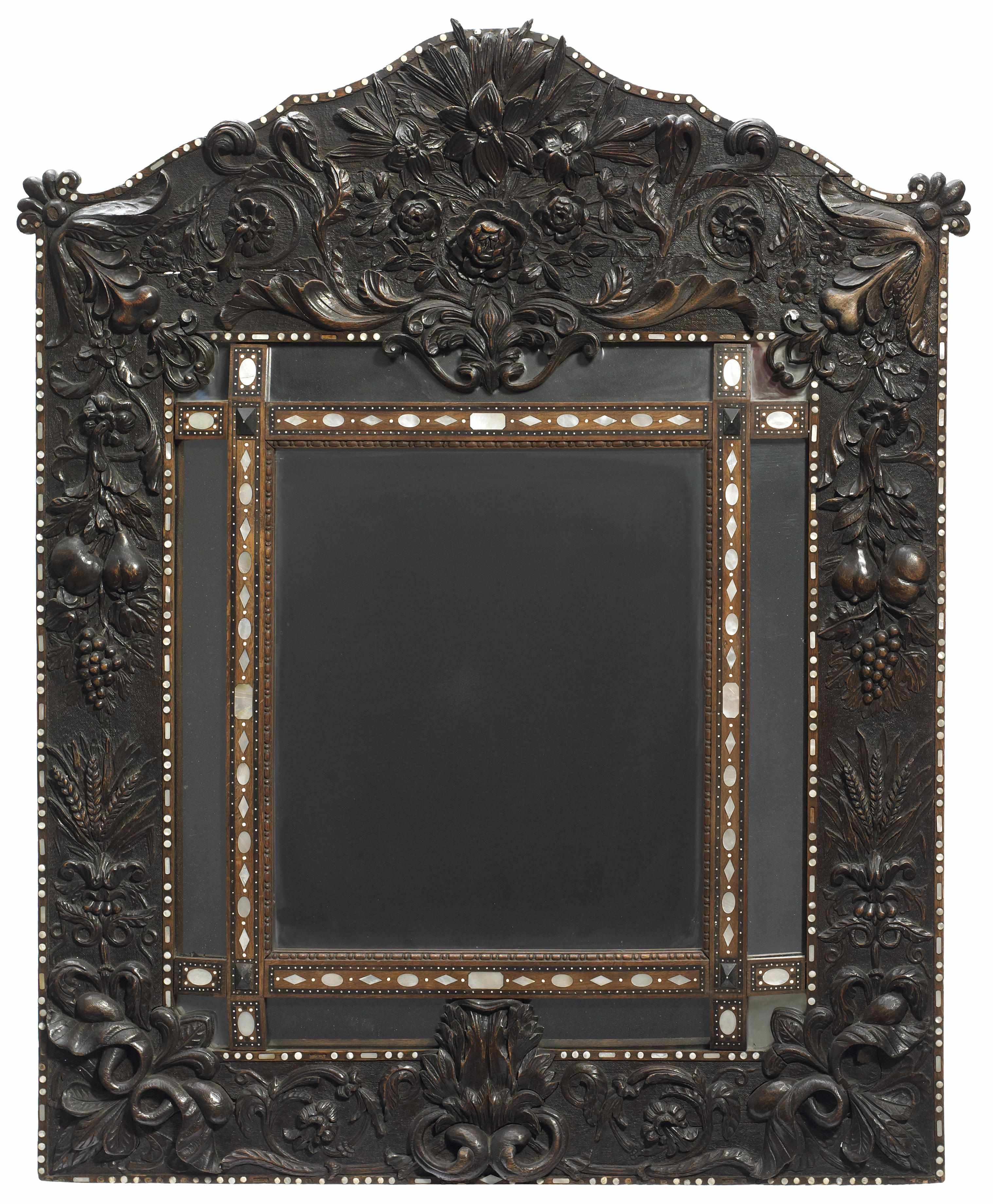 Appraisal: A Continental Baroque style shell inlaid carved oak mirror height