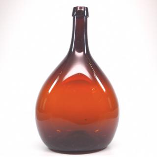 Appraisal: Free A mid th century free-blown glass chestnut bottle Dark