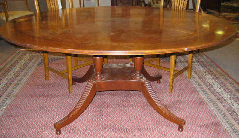 Appraisal: BAKER MAHOGANY CIRCULAR DINING TABLE With line inlaid top on