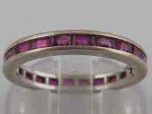 Appraisal: A white metal tests carat gold ruby set eternity ring