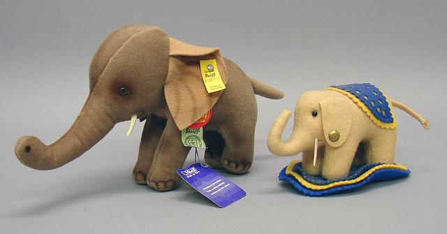 Appraisal: Pair of elephants L Tagged beige felt with blue and