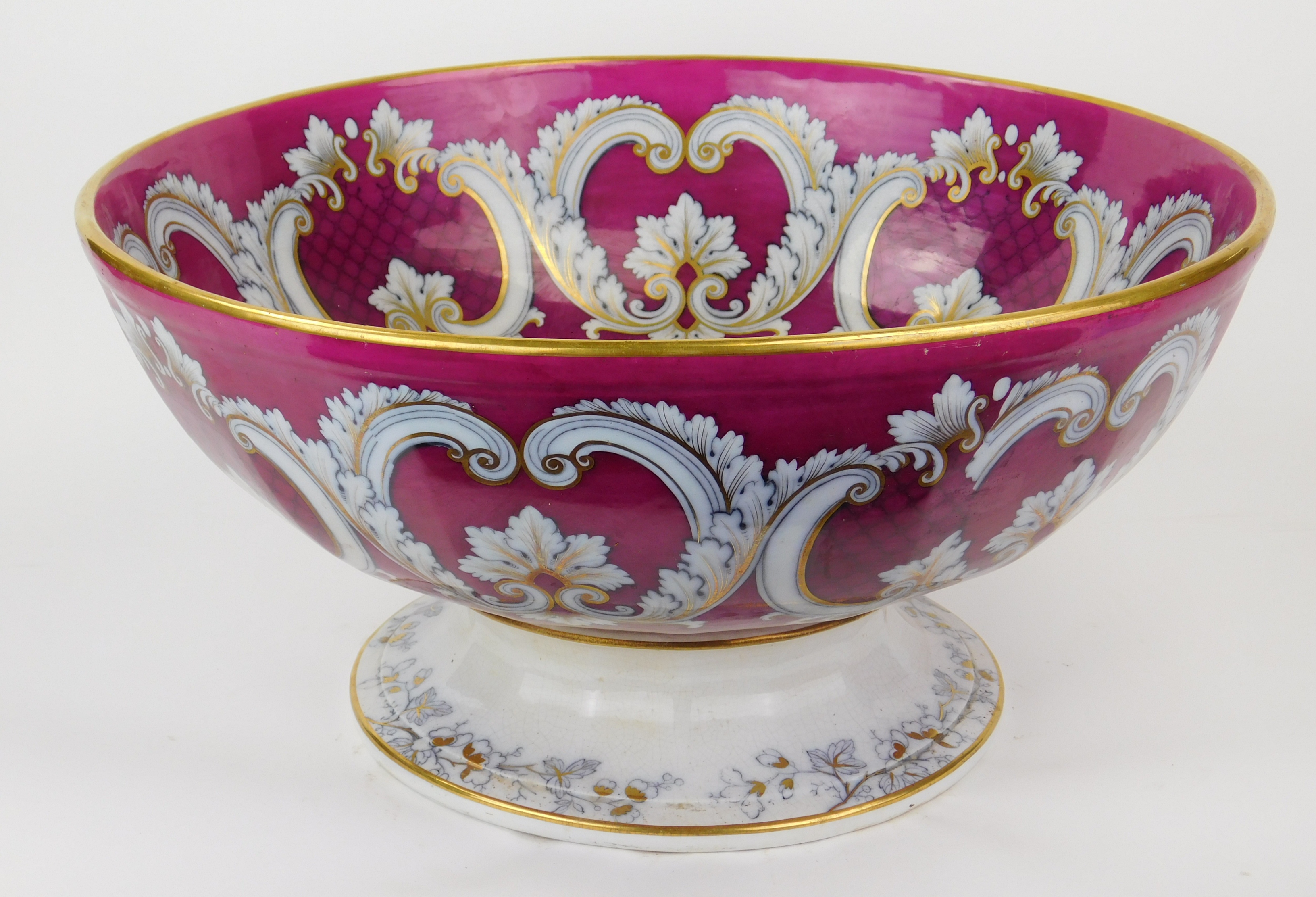 Appraisal: Large porcelain footed punch bowl fuscia ground with white leaf