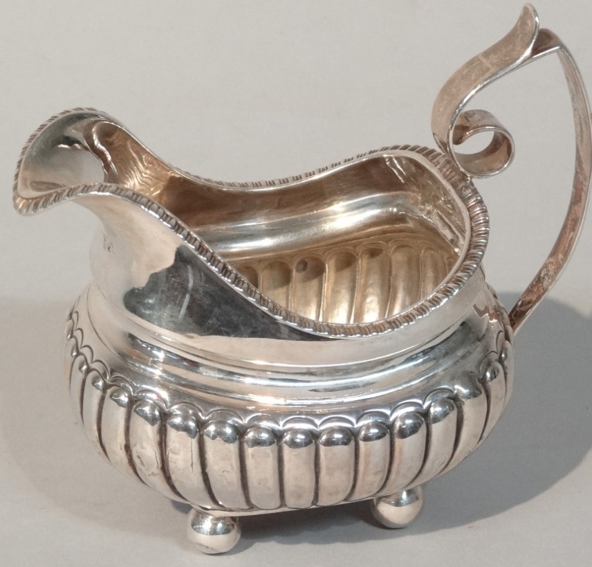 Appraisal: A thC silver cream jug of shaped form with a