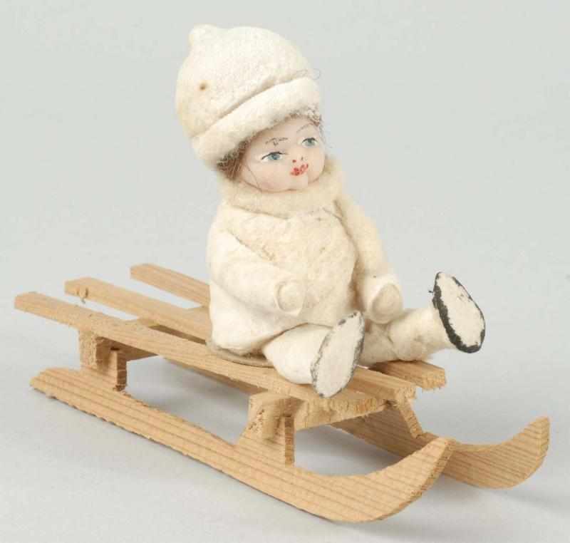 Appraisal: Child on Sleigh Candy Container Description Marked Germany on sleigh