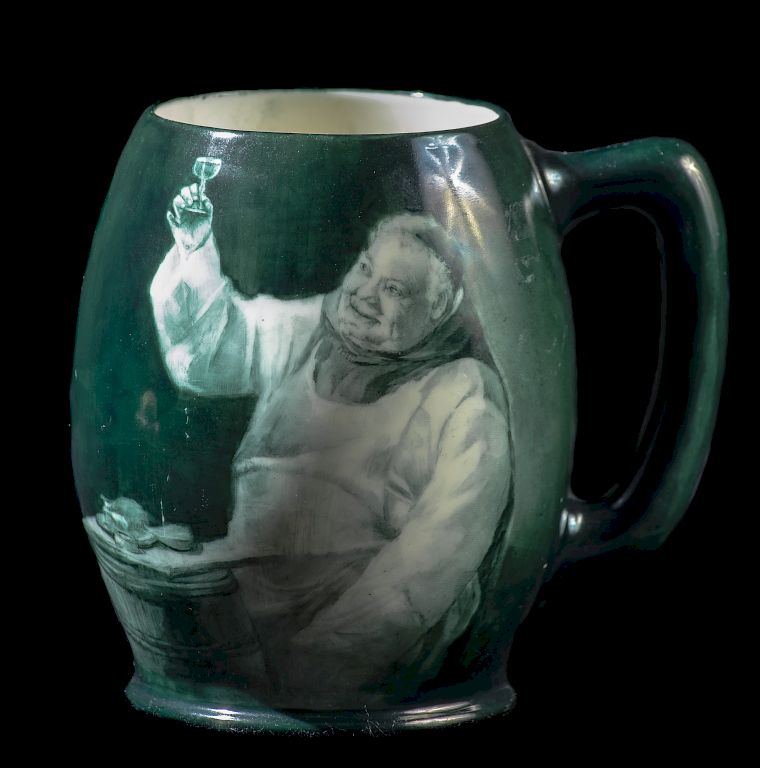 Appraisal: Belleek Portrait Mug Green Tone Mug Featuring A Man Toasting