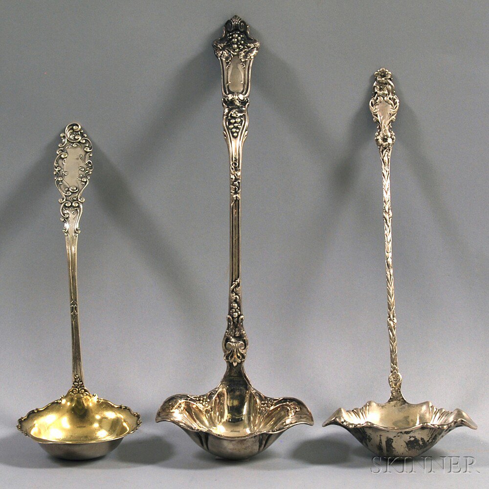 Appraisal: Three Ladles a large silver-plated ladle with grapevine decoration a