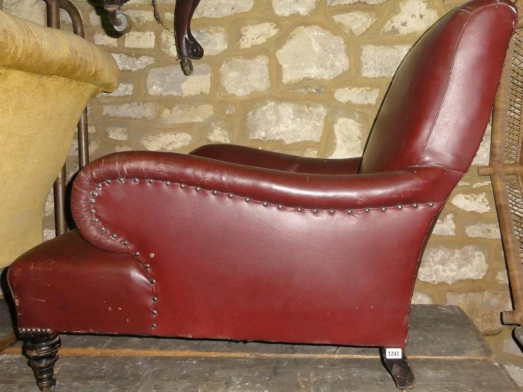 Appraisal: A late Victorian Edwardian low armchair deep seated burgundy leather