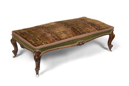 Appraisal: A Victorian rosewood long footstool circa the serpentine seat covered