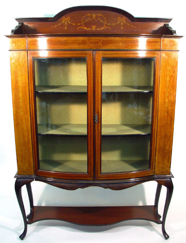 Appraisal: Edwardian mahogany bow fronted china cabinet with swag and bow