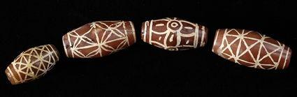 Appraisal: Four Carnelian Beads with White Decoration