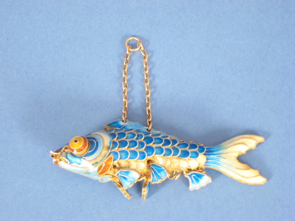 Appraisal: A blue and cream enamelled articulated Fish with yellow and