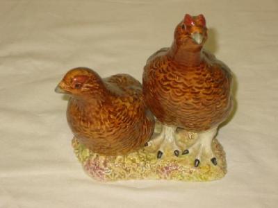 Appraisal: A BESWICK POTTERY GROUP modelled as two grouse No wide