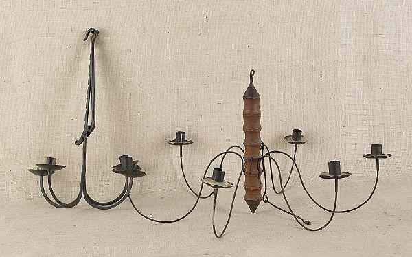 Appraisal: Contemporary iron chandelier together with a wood and tin chandelier