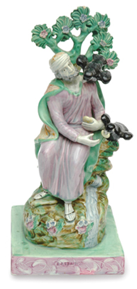 Appraisal: A STAFFORDSHIRE FIGURE OF ELIJAH Being brought food by the