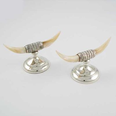 Appraisal: A pair of mother of pearl mounted knife rests modelled