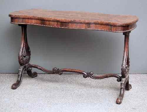 Appraisal: A Victorian rosewood centre table of serpentine outline on leaf