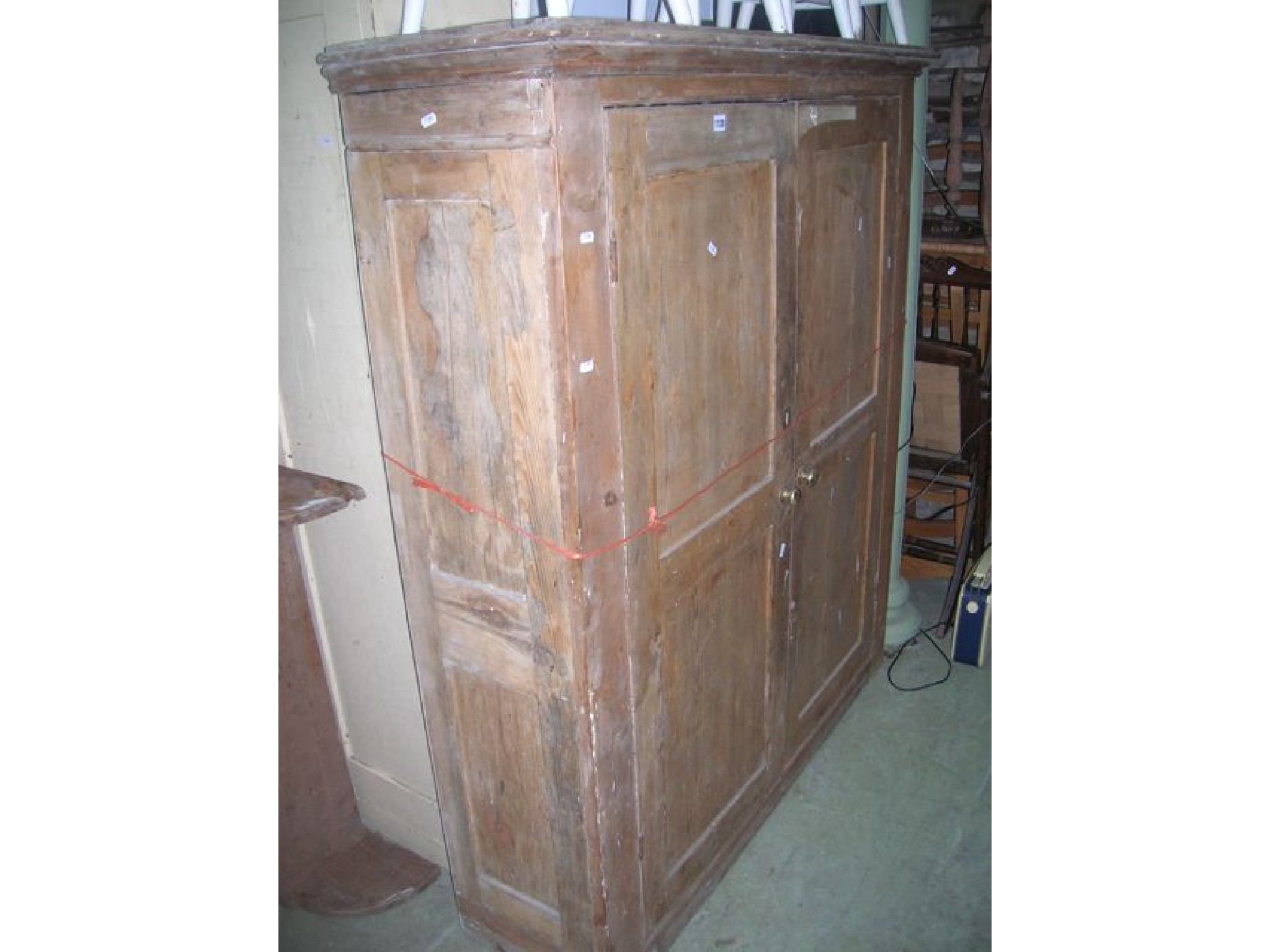 Appraisal: A th century stripped pine side cupboard enclosed by a